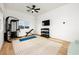 Bright home gym featuring weight rack, blue yoga mat, ceiling fan and wood-style floors at 10420 Luella Ct, Las Vegas, NV 89143