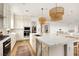 Open-concept kitchen with stainless steel appliances, spacious island, and modern lighting fixtures at 10420 Luella Ct, Las Vegas, NV 89143