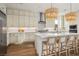 Modern kitchen featuring stainless steel appliances, a large island, and elegant pendant lighting at 10420 Luella Ct, Las Vegas, NV 89143