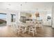 Bright, open kitchen featuring a large island, stainless steel appliances, and a dining area with modern decor at 10420 Luella Ct, Las Vegas, NV 89143