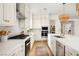Modern kitchen with stainless steel appliances and white countertops with golden hardware at 10420 Luella Ct, Las Vegas, NV 89143