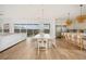 Open concept kitchen and living room with dining table and chairs and oversized island with bar stools at 10420 Luella Ct, Las Vegas, NV 89143