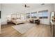 Spacious primary bedroom with a king bed, sitting area, natural light, and stylish decor at 10420 Luella Ct, Las Vegas, NV 89143