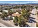 The aerial view captures neighborhood homes, streets, mature trees and highlights the property's expansive lot at 10615 Rancho Destino Rd, Las Vegas, NV 89183