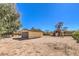 View of the backyard with a garage and storage shed at 10615 Rancho Destino Rd, Las Vegas, NV 89183