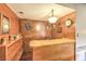 An indoor bar area featuring wood paneled walls and a light wood bar-top, decorated with novelty items at 10615 Rancho Destino Rd, Las Vegas, NV 89183