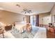 A serene bedroom features neutral walls, tile flooring, a ceiling fan, and a comfortable, inviting bed at 10615 Rancho Destino Rd, Las Vegas, NV 89183