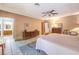 A neutral-toned bedroom boasts tile floors, coordinated furnishings, and views into an adjacent bathroom at 10615 Rancho Destino Rd, Las Vegas, NV 89183