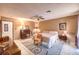 A cozy bedroom is furnished with warm wall colors, tile flooring, and coordinated furniture and decor at 10615 Rancho Destino Rd, Las Vegas, NV 89183
