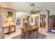 Cozy dining room featuring a ceiling fan, chandelier, tile floors and a view of the backyard from its large windows at 10615 Rancho Destino Rd, Las Vegas, NV 89183