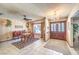 Inviting dining area with chandelier, ceiling fan, tile floors, and double doors, perfect for entertaining at 10615 Rancho Destino Rd, Las Vegas, NV 89183
