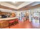 Bright, tiled-floor kitchen with breakfast bar, open to a living space with a fireplace and a dining room at 10615 Rancho Destino Rd, Las Vegas, NV 89183