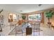 Cozy living room featuring neutral walls, decorative plants, and a large window with backyard views at 10615 Rancho Destino Rd, Las Vegas, NV 89183