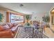 Comfortable living room with unique decor, tile flooring, and bright windows, creating a welcoming space at 10615 Rancho Destino Rd, Las Vegas, NV 89183
