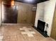 Cozy basement with brick fireplace, wood-paneled walls, and tiled floors, ready for relaxation and entertainment at 1201 Madison Ave, Las Vegas, NV 89106