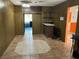 Retro basement area with tile floor, wood paneling, bar, and access to other rooms of the house at 1201 Madison Ave, Las Vegas, NV 89106