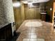 Spacious basement featuring a brick fireplace, wood-paneled walls, and a retro bar area for entertaining at 1201 Madison Ave, Las Vegas, NV 89106