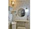 Bathroom with a round mirror, lighted vanity, and ornate light fixture at 1201 Madison Ave, Las Vegas, NV 89106