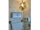 Bathroom featuring classic floral wallpaper, decorative shelving, and an ornate light fixture at 1201 Madison Ave, Las Vegas, NV 89106