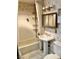 Traditional bathroom featuring a pedestal sink, mirrored cabinet, and shower with built-in shelving at 1201 Madison Ave, Las Vegas, NV 89106