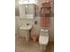 Bathroom featuring pink accessories and patterned wall and floor tiles at 1201 Madison Ave, Las Vegas, NV 89106