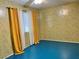 Bedroom with yellow patterned walls, blue floor, and natural light through the window at 1201 Madison Ave, Las Vegas, NV 89106