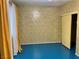 Bedroom featuring wallpaper, blue flooring, window and sliding door closet at 1201 Madison Ave, Las Vegas, NV 89106