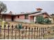 Charming single-story home with unique desert landscaping and a decorative black metal fence at 1201 Madison Ave, Las Vegas, NV 89106