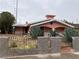 Charming single-story home with desert landscaping, and a fence surrounding the front yard at 1201 Madison Ave, Las Vegas, NV 89106