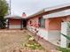Charming home with desert landscaping, white brick accents, and beautiful flowers in the front yard at 1201 Madison Ave, Las Vegas, NV 89106