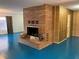 A striking brick fireplace anchors this room with blue floors and retro wallpaper at 1201 Madison Ave, Las Vegas, NV 89106