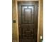 Dark brown front door with geometric design and wood paneling at 1201 Madison Ave, Las Vegas, NV 89106