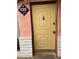 Inviting front door with stone and pink facade and custom address plaque, offering a warm welcome to the home at 1201 Madison Ave, Las Vegas, NV 89106