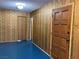 Hallway displaying vintage striped wallpaper, wooden doors, and blue flooring at 1201 Madison Ave, Las Vegas, NV 89106