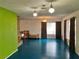 Spacious living room featuring blue floor, brick fireplace, textured walls, and large windows at 1201 Madison Ave, Las Vegas, NV 89106