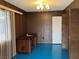 Retro office with wood paneling, vintage desk, blue floor, and unique chandelier at 1201 Madison Ave, Las Vegas, NV 89106