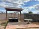Backyard outdoor kitchen and dining area with desert landscaping and a view of blue skies at 1201 Madison Ave, Las Vegas, NV 89106