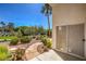Picturesque backyard showcasing desert landscaping, a flagstone walkway, and thriving trees and plants at 1363 Rolling Sunset St, Henderson, NV 89052