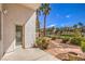 Relaxing backyard area that features well-maintained desert landscaping, with a walkway and various desert plants at 1363 Rolling Sunset St, Henderson, NV 89052