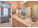Lovely bathroom featuring double sinks, neutral color scheme, and access to the bedroom at 1363 Rolling Sunset St, Henderson, NV 89052