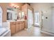 Well-lit bathroom featuring dual sinks, walk-in shower, and separate toilet room at 1363 Rolling Sunset St, Henderson, NV 89052