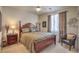 Comfortable bedroom with a wooden bed frame, soft carpet, and warm, natural light from the window at 1363 Rolling Sunset St, Henderson, NV 89052