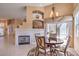 Breakfast nook next to fireplace with sliding glass doors at 1363 Rolling Sunset St, Henderson, NV 89052