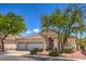 Charming single-story home with well-maintained landscaping, a three-car garage and desert landscaping with mature trees at 1363 Rolling Sunset St, Henderson, NV 89052