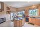 Kitchen with views to the breakfast nook fireplace and backyard at 1363 Rolling Sunset St, Henderson, NV 89052