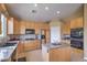 Kitchen with wooden cabinets, granite countertops, and modern appliances at 1363 Rolling Sunset St, Henderson, NV 89052