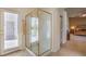 Modern bathroom showing a glass-enclosed shower, access to the backyard, and neutral tones at 1363 Rolling Sunset St, Henderson, NV 89052