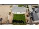 An aerial view reveals a spacious backyard with a verdant lawn, mature trees, and outdoor recreational equipment at 1395 Logandale Dr, Logandale, NV 89021