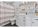 Bathroom with striped shower curtain, vanity, and modern fixtures at 1395 Logandale Dr, Logandale, NV 89021