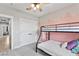 Bedroom with carpet floors, ceiling fan, modern paint scheme, and a double closet at 1395 Logandale Dr, Logandale, NV 89021